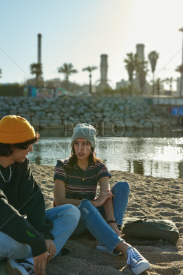 Attractive young couple having a chat outdoors