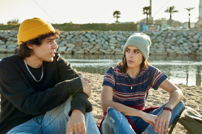 Cute couple having a chat on beach sand