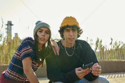 Cute couple looking at camera outdoors