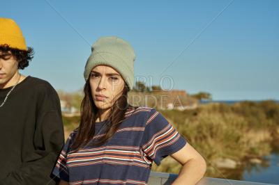 Girl looking at camera while standing with guy