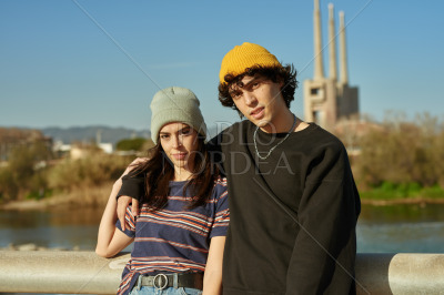 Guy with arm around his girl outdoors