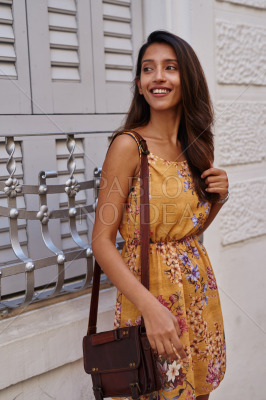 Happy lady, standing next to shutter bars
