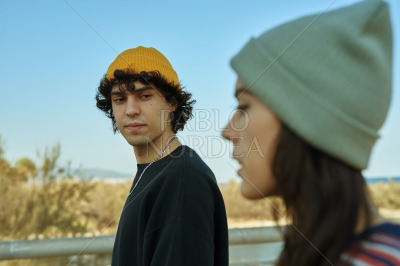 Two calm young people talking a walk outside