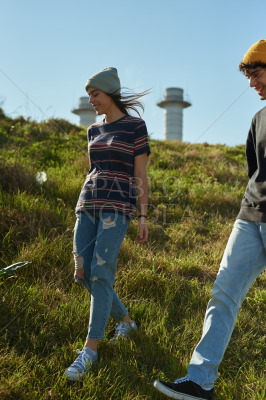 Two cheery young people walking down a hill