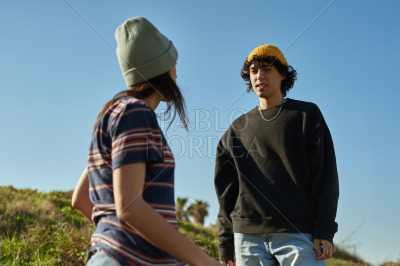 Two content young people standing on a hill
