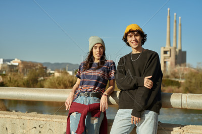Young couple smiling at camera outdoors