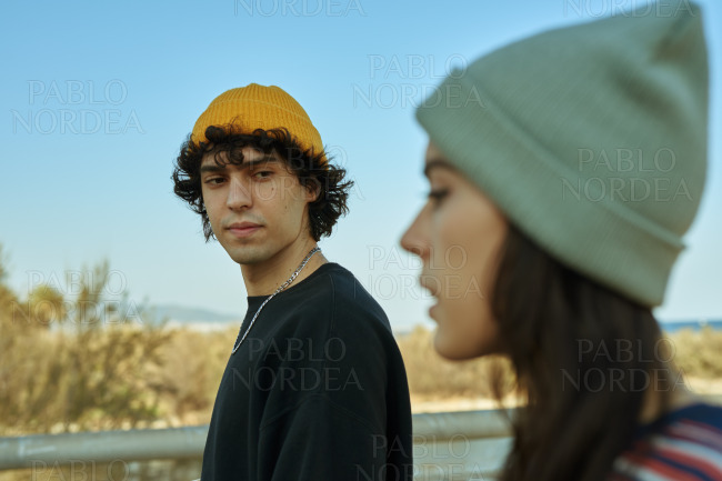Two calm young people talking a walk outside