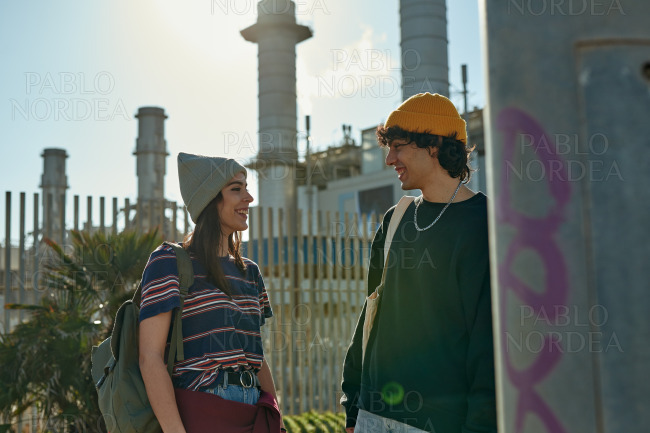 Two captured young people standing outside talking