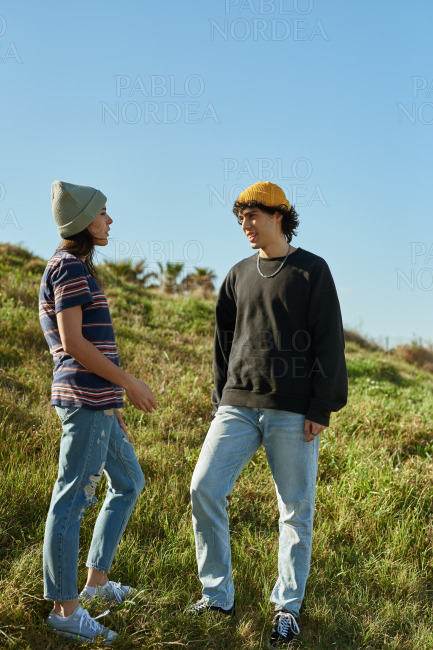 Two rapt young people having a casual conversation