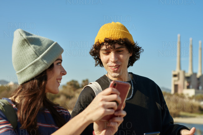 Two thrilled young people having a happy chat stock photo