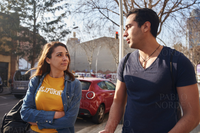 Woman in yellow t shirt looks up at a man