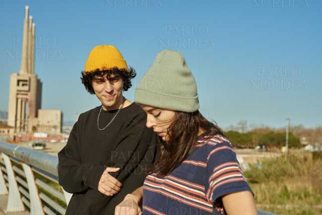 Young couple having a discussion on a bridge