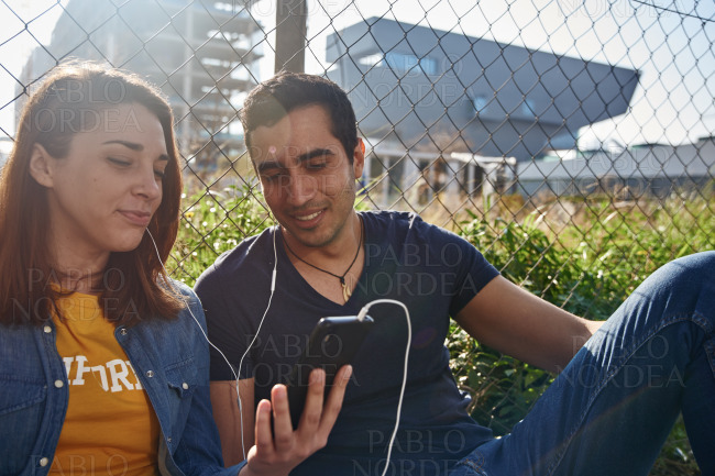 Young couple looking at a cell phone together