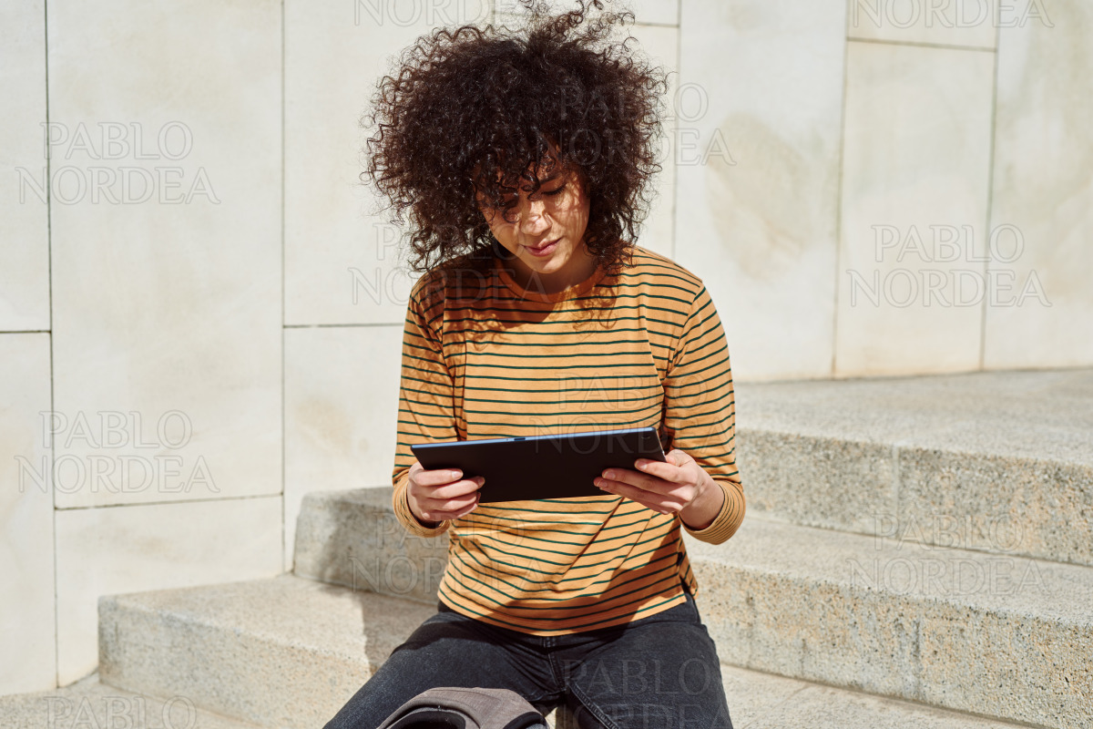 Cute girl reading something on her tablet pc stock photo