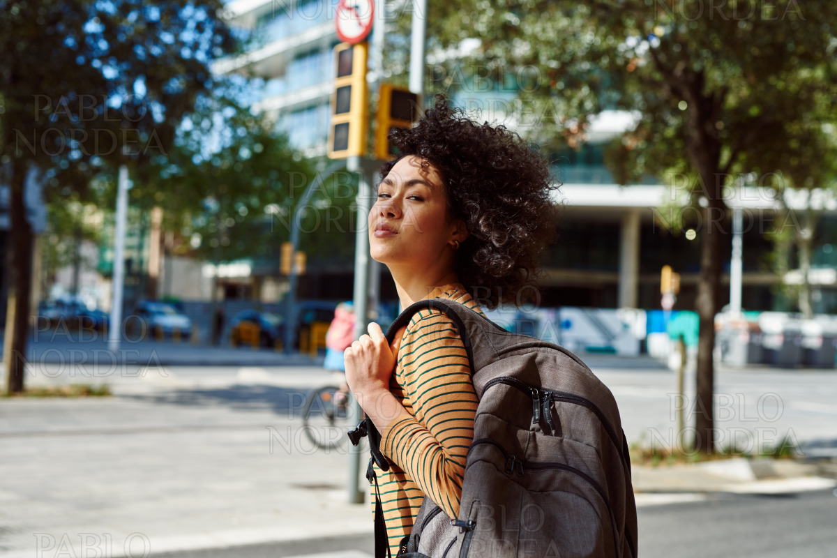 Cute girl with backpack looking at you stock photo