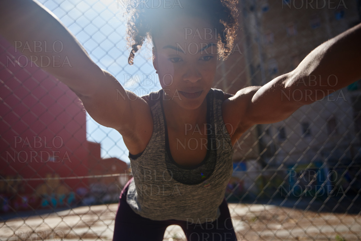 Fit young african american woman working out alone stock photo