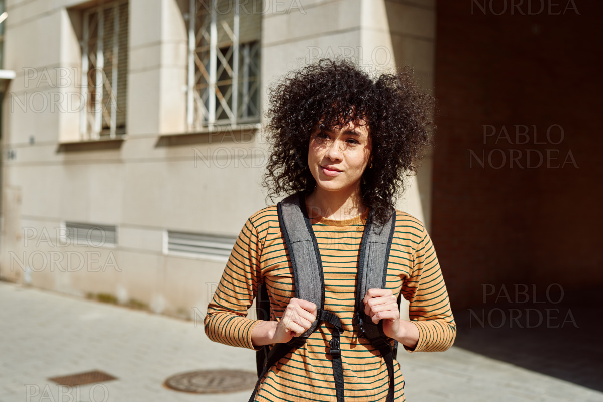 Young female student standing with a backpack stock photo