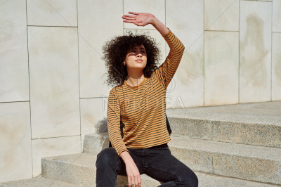 Attractive girl blocking the sun with her hand