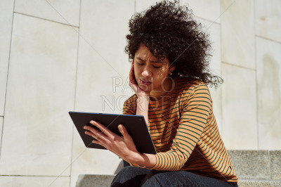 Attractive girl reading something on her tablet pc