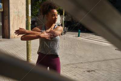 Attractive young woman exercising alone outside