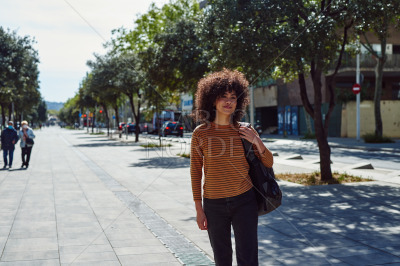 Attractive young woman walking with a backpack