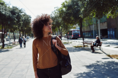Cute girl looking around while walking
