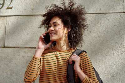 Cute girl taking a phone call outdoors