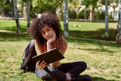 Cute young woman reading from her tablet pc