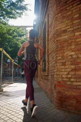 Dedicated young woman jogging in the city