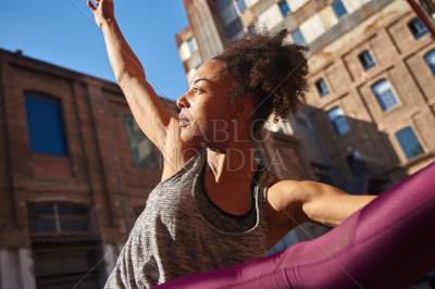 Fit young woman exercising alone in the city