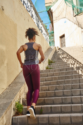 Fit young woman jogging on the stairs