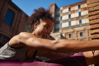 Sporty young woman exercising in the city