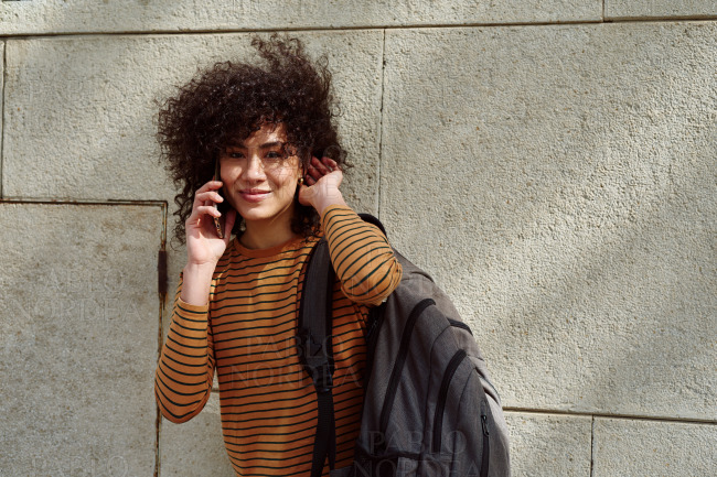 Beautiful black girl taking a phone call outdoors