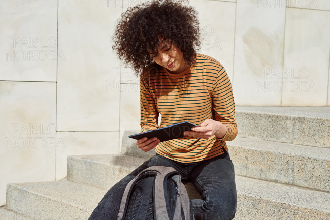 Girl reading from her tablet pc outdoors