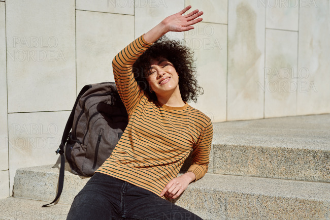 Smiling black girl blocking the sun with her hand stock photo