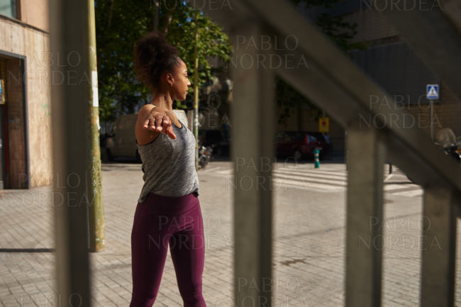 Young black woman exercising alone outside