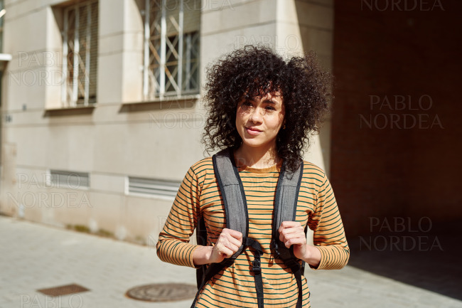 Young female student standing with a backpack
