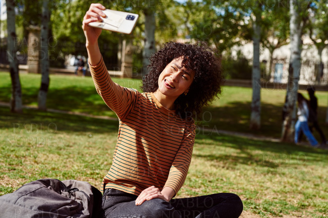 Young woman taking a selfie in a park