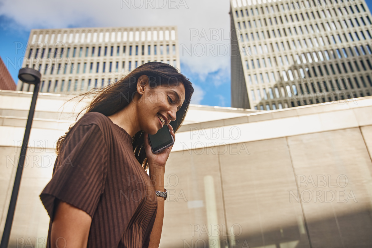 Beautiful young businesswoman standing on street stock photo