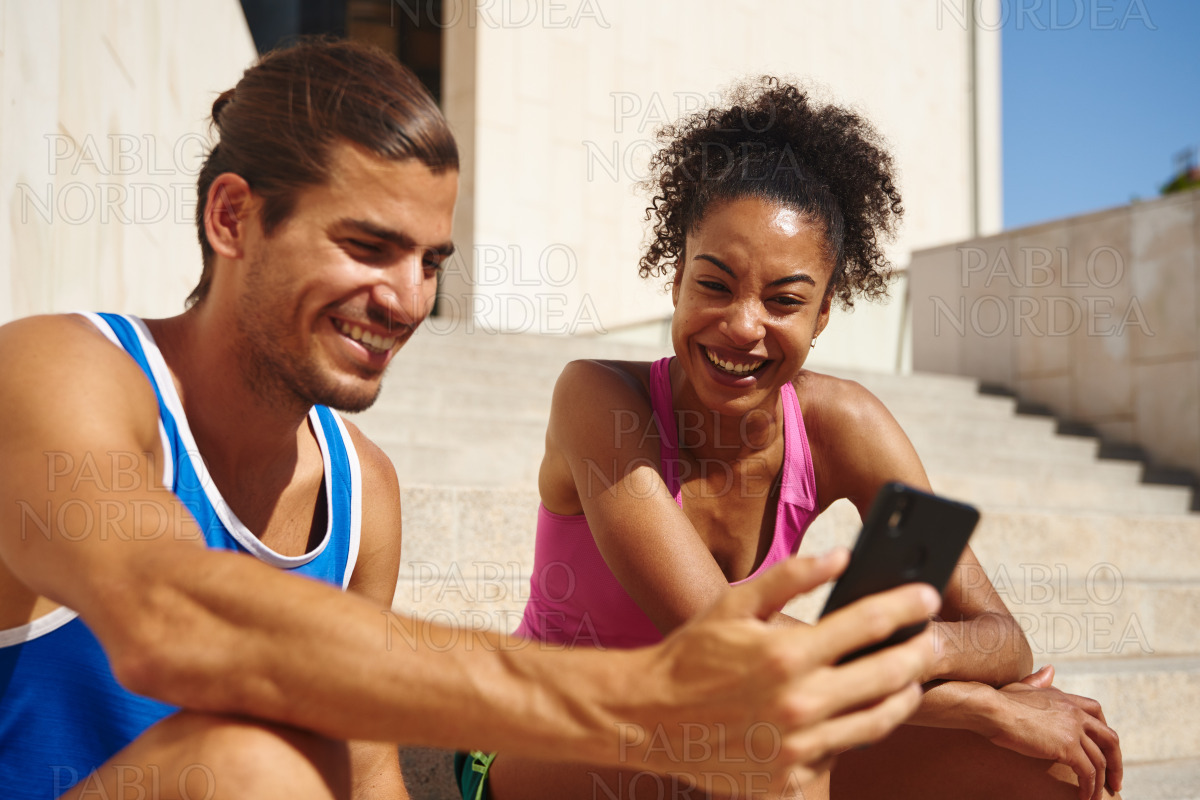 Smiling couple surfing the net on together stock photo