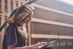 Young beautiful businesswoman sitting with tablet
