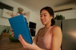 Young woman holding tablet during yoga