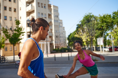 Active couple exercising together in the city