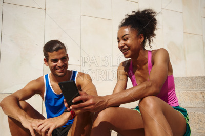 Active couple surfing the net together outdoors