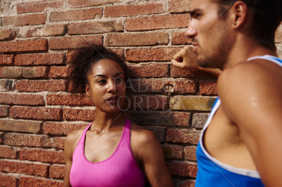 Athletic couple having a chat together outdoors