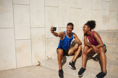 Athletic couple taking a selfie together outdoors