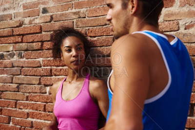 Athletic young couple chatting together outdoors