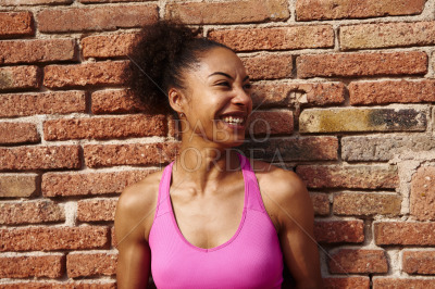 Athletic young woman looking away cheerfully