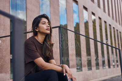 Beautiful businesswoman with hand on knee