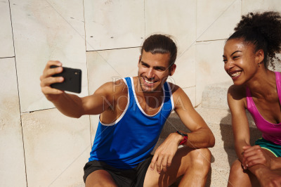 Cheerful couple taking a selfie together outdoors